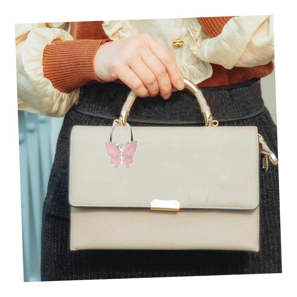 Stilvoller Handtaschenhalter Tragbarer Schmetterlings-Taschenhaken für Tische - Platzsparend falten und schnallen Sie Ihre Einkaufstasche elegant ab! Ideal für unterwegs